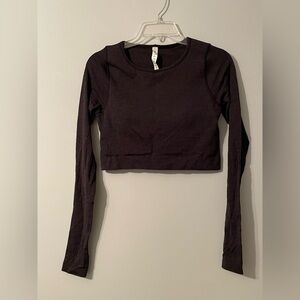 Never worn, original packaging- no tags, crop w/ built-in sports bra, med.